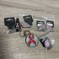 Front view showing five packaged necklaces and one keychain