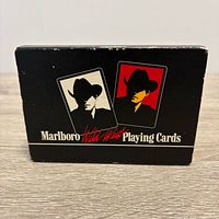 Closed black sleeve featuring two cowboy silhouette images and Marlboro Wild West Playing Cards text
