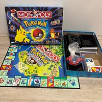 Box lid, unfolded game board, inner tray visible