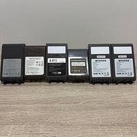 Front view of six dark gray replacement battery packs standing upright