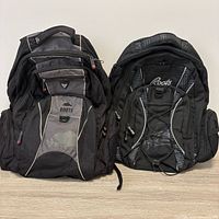 Both Roots backpacks side by side front view