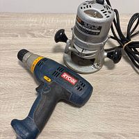 Ryobi drill and SKIL router side by side