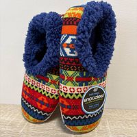Front and side view of slippers showing multicolor knit exterior and navy lining with tag attached