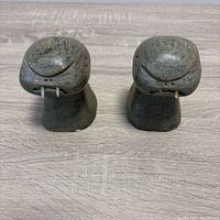 Front view of both soapstone walrus figurines showing tusks and finish