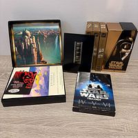 All contents: three Special Edition VHS tapes, Trilogy slipcase, Episode I collector DVD box opened with inserts