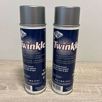 Front view of two Twinkle stainless steel cleaner aerosol cans