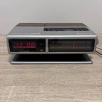 Front view showing LED display reading 12:00, radio dial, overall condition