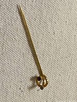 Full view of gold stick pin