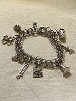Full bracelet coiled showing chain and multiple charms