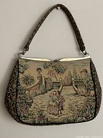 Front view showing tapestry scene, frame and handle