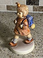 Front right view of schoolgirl figurine showing overall form, colors, and condition