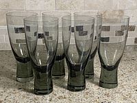 Six smoked gray Holmegaard glasses standing upright