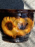 Side view showing sunflower motif and glaze colors