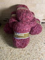 Front view of stacked Patons Divine Richest Rose skeins