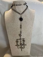 Full front view of sterling silver rosary lariat necklace on bust showing bead chain, onyx station, crucifix cluster pendant