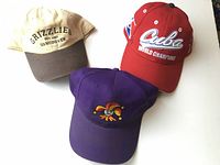 Overview of three sports caps laid out on table