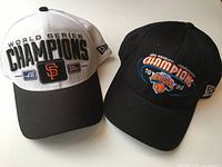 Both hats front view showing championship embroidery