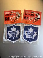 Front view of two sealed Toronto Maple Leafs crests in original headers