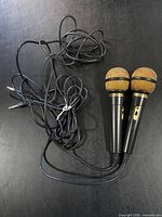 Two Venturer handheld microphones with attached cords