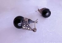 Marcasite huggie earrings showing black faux pearl and clasp detail
