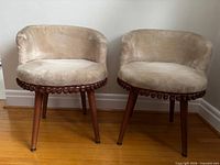 Front view of both cream velour accent chairs