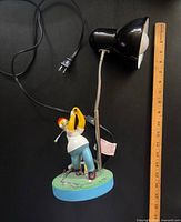Full view of Homer Simpson lamp with power cord and ruler for scale