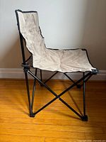 Side view of folded-out camp chair showing frame construction and fabric