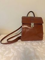 Front view showing flap, clasp, logo and overall shape