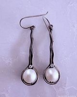 Front view of both earrings showing design, pearls, accent stones, oxidized finish