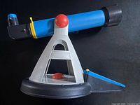 Side view assembled showing blue telescope in grey triangular stand with black base