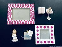 All five items laid out: gift box, candle, angel figurine, two photo frames