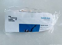 Wrapped signed pointe shoes with visible Isabelle Bratt bio sheet