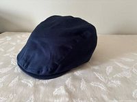 Front angled view of navy newsboy cap
