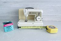 Singer Little Touch & Sew sewing machine with AC adapter box and tape measure for scale