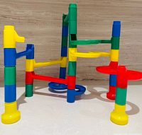 assembled view of multicolour marble run showing supports, curves and funnel