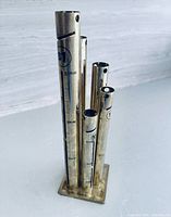 Full view of brass-tone 5-tube coin sorter bank showing $1 tube