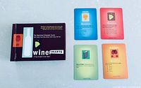 Front view of boxed Wine Smarts trivia card game with four sample cards laid out