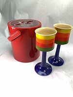 Overall shot: red plastic ice bucket with lid, two striped ceramic goblets