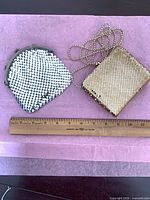 Both metal mesh bags beside ruler for scale