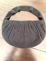 Full view of beaded shoulder bag front showing shape and strap