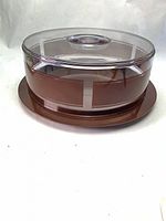 Side view of cake carrier with lid on tray