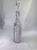 Full view of crystal decanter with stopper