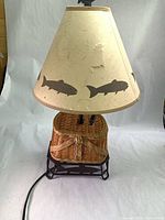 Lamp assembled with shade showing fish silhouettes