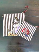 Both cosmetic pouches front view illustrating size difference and stripe pattern