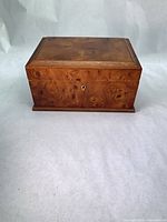 Closed burl wood jewelry box front view showing lock