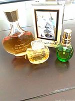 Group shot of all four mini perfume bottles including boxed Salvador Dalí