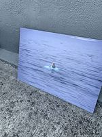 Front view of metal print leaning against wall