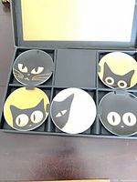 Open box showing four of the cat face plates and empty slot