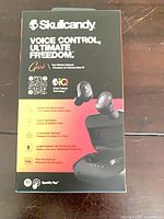 Front of retail box displaying Skullcandy Grind earbuds and key features