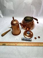 All components: copper teapot, coffee pot body, lid, wood handle, ceramic sleeve, copper caps with ruler for scale
